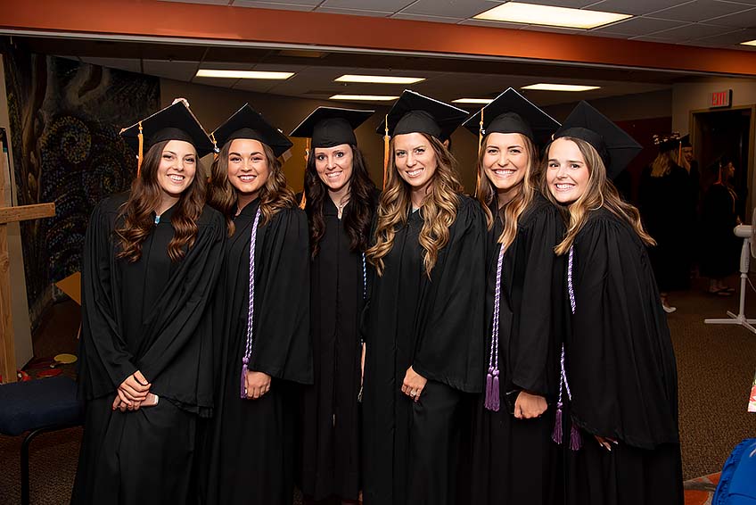 A group of graduates pose for a photo before the ceremony.